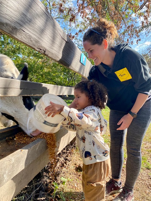 Mother and daughter feeding the cow together.