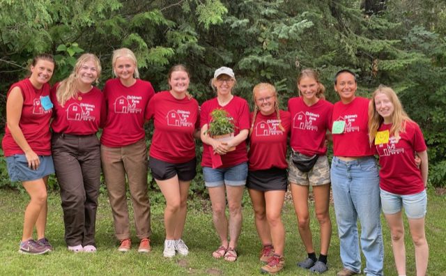 Summer staff members wearing their red Children's Farm t-shirts.